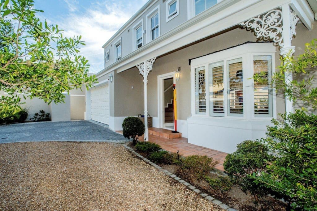 The outside of the house. Ample parking area behind secure gate.