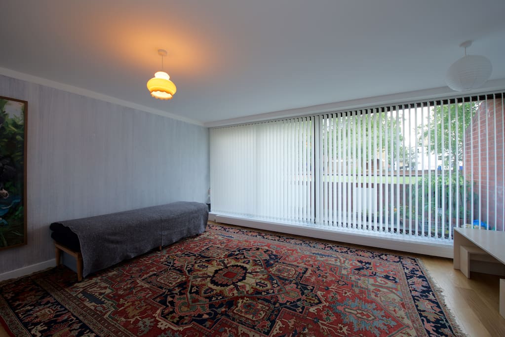 Living room, balcony. Blinds offer shade and privacy. We don't have this rug anymore but a smaller one.