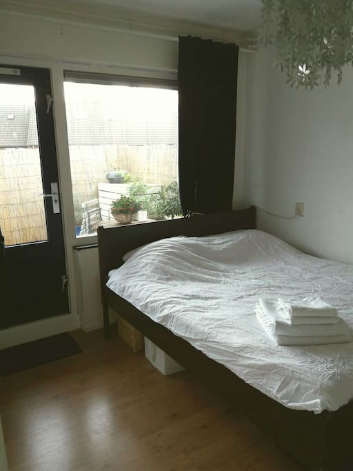 The bedroom with entry to the balcony and bathroom