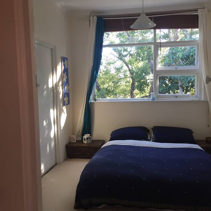 Bedroom. Very cosy, slightly firm queen size mattress on floor. Mattress has wool mattress protector for extra warmth. There is a heater & hot water bottle too. You can access the bathroom from this room as well.