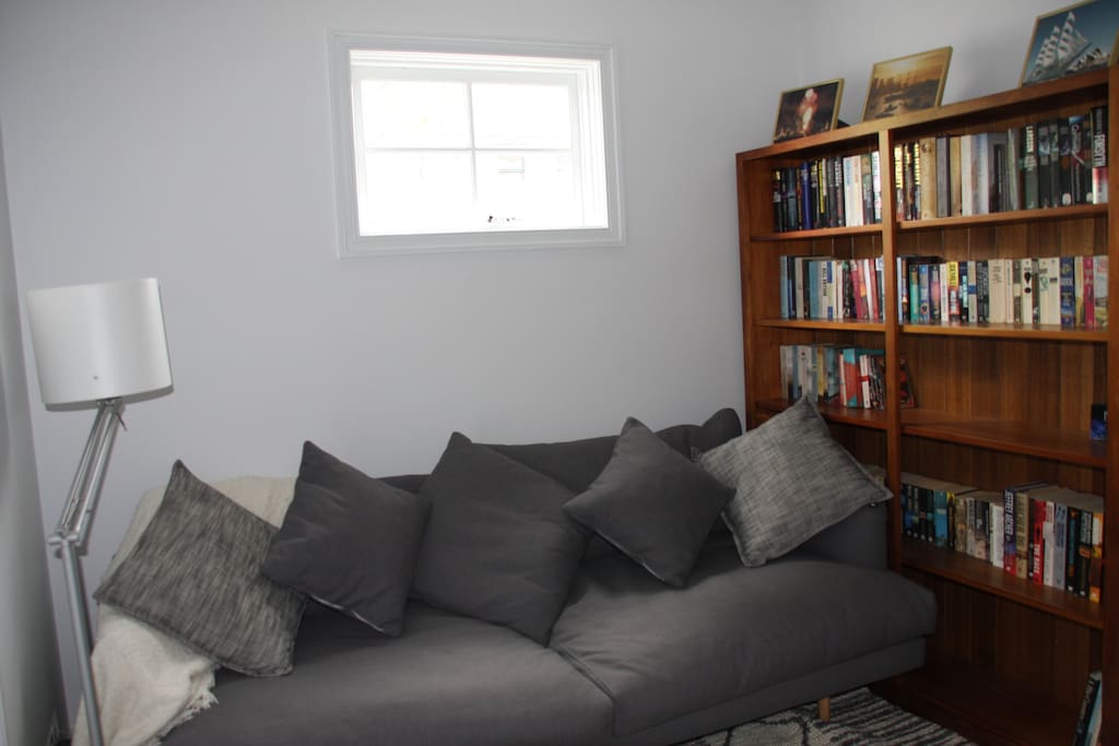 comfy couch in the sitting room with penty of books
