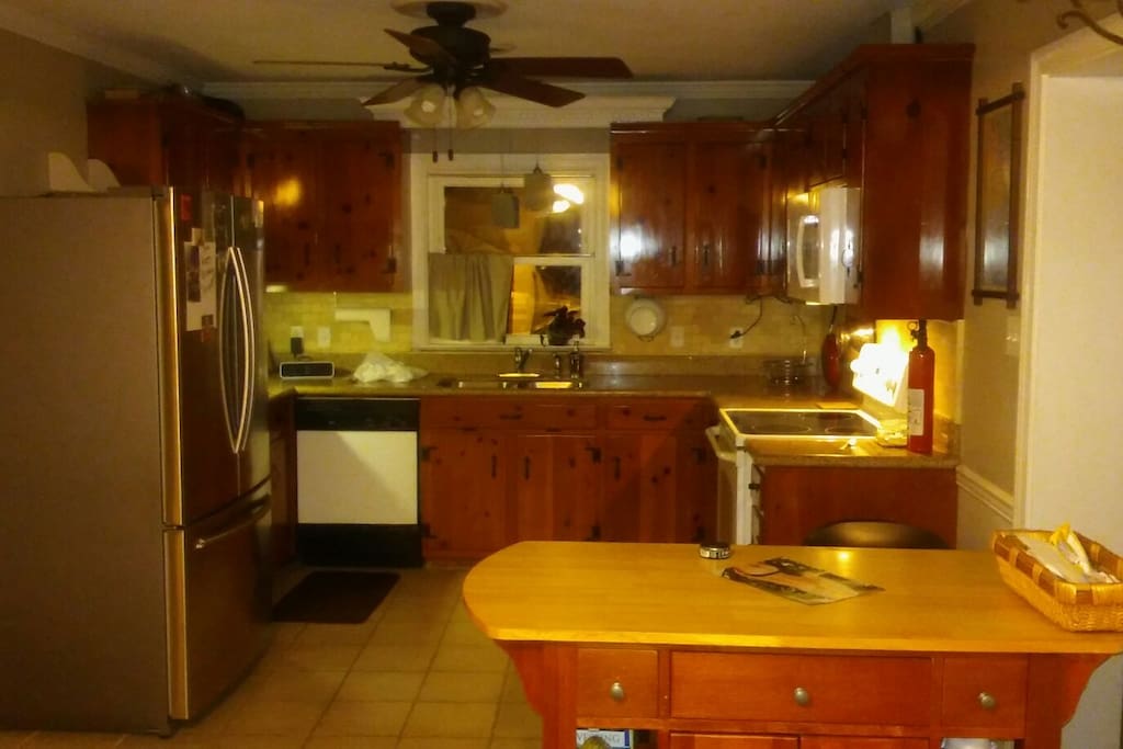 Kitchen has new fridge, granite, and tile.