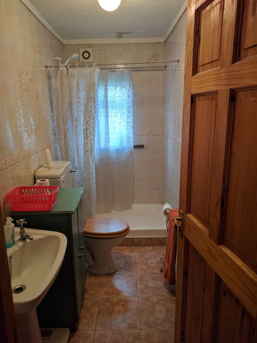 Private bathroom with an electric shower.