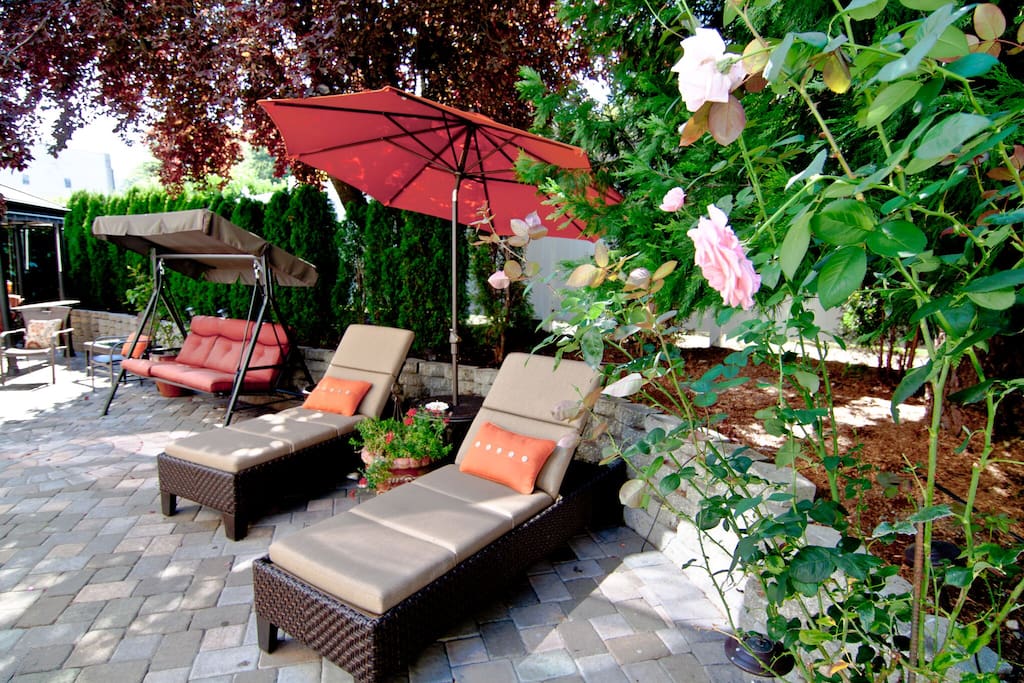 The perfect getaway... chaise lounges, patio seating, a firepit, and a secret garden!