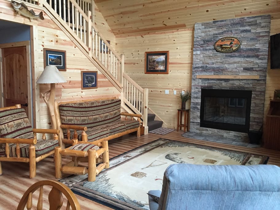 Living room with fireplace and log furniture.