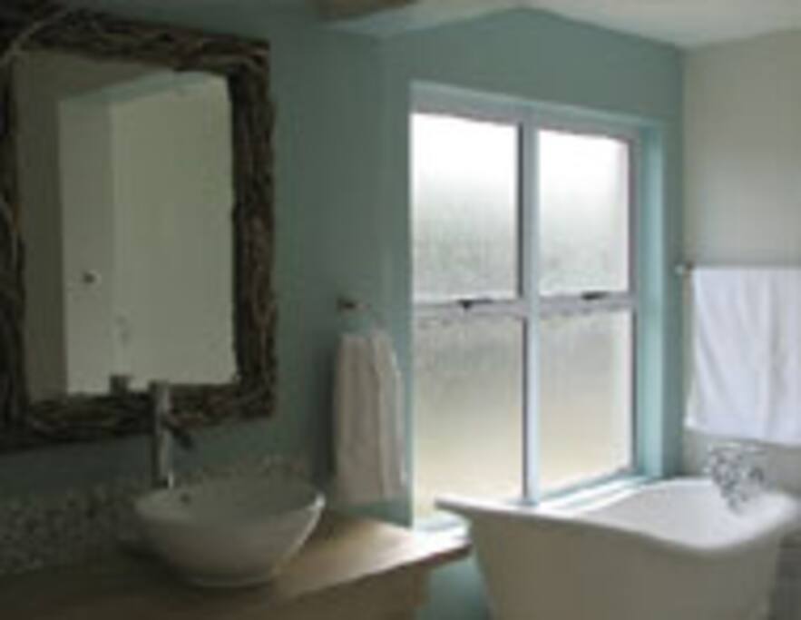 En-suite to master bedroom shower, bath toilet & wash basin