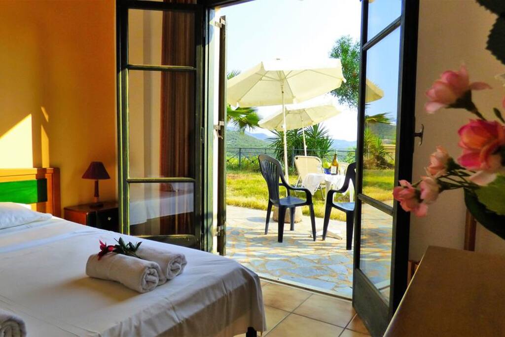 The bedroom with the double bed and the balcony