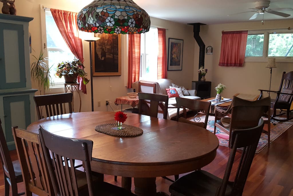 Dining room connects kitchen and living room with wood stove