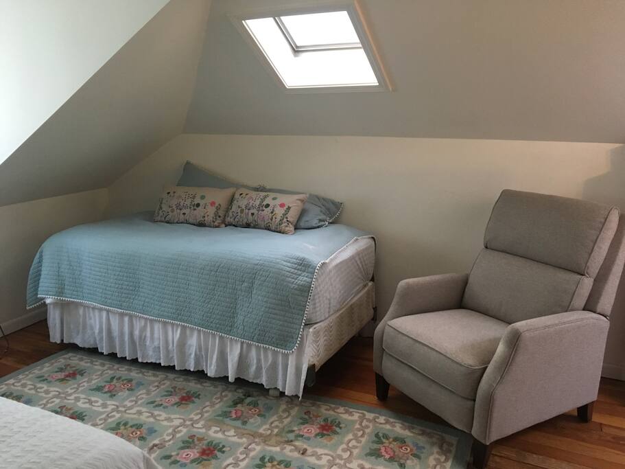 Front bedroom has reclining chair and twin bed.