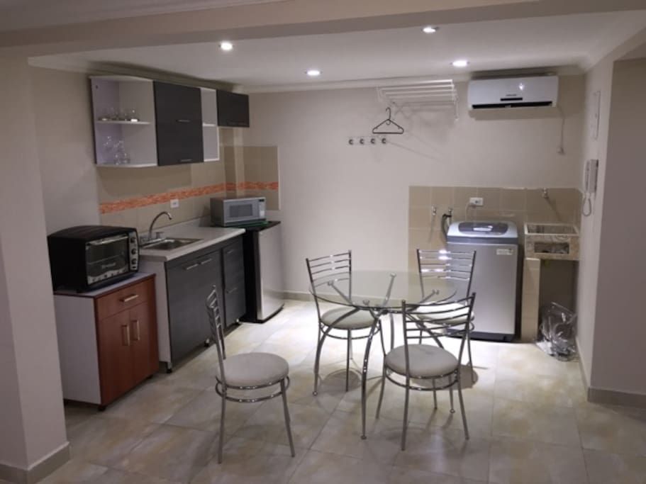 Full kitchen with stove, washer and AC