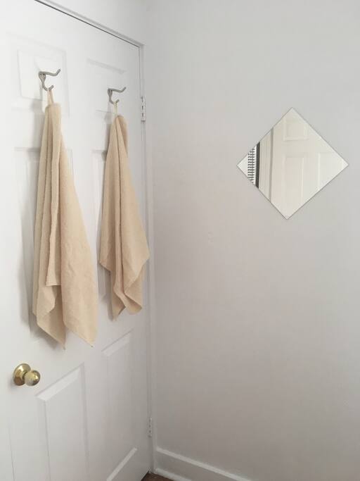 Bedroom mirror, fresh towels provided.