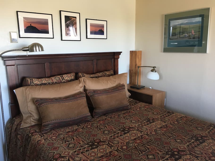 The queen size bed, which looks out over the small sofa to the picture window and beyond!