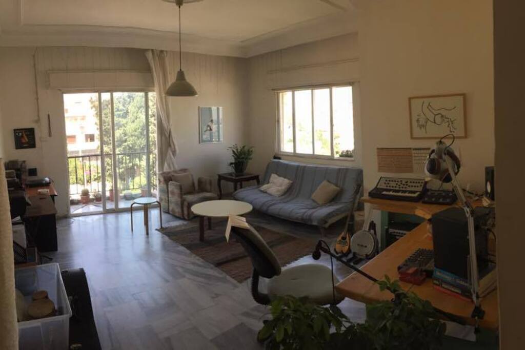 Living space from a different angle, showing the sofa bed and the little balcony overlooking the skyline of Abdali boulevard