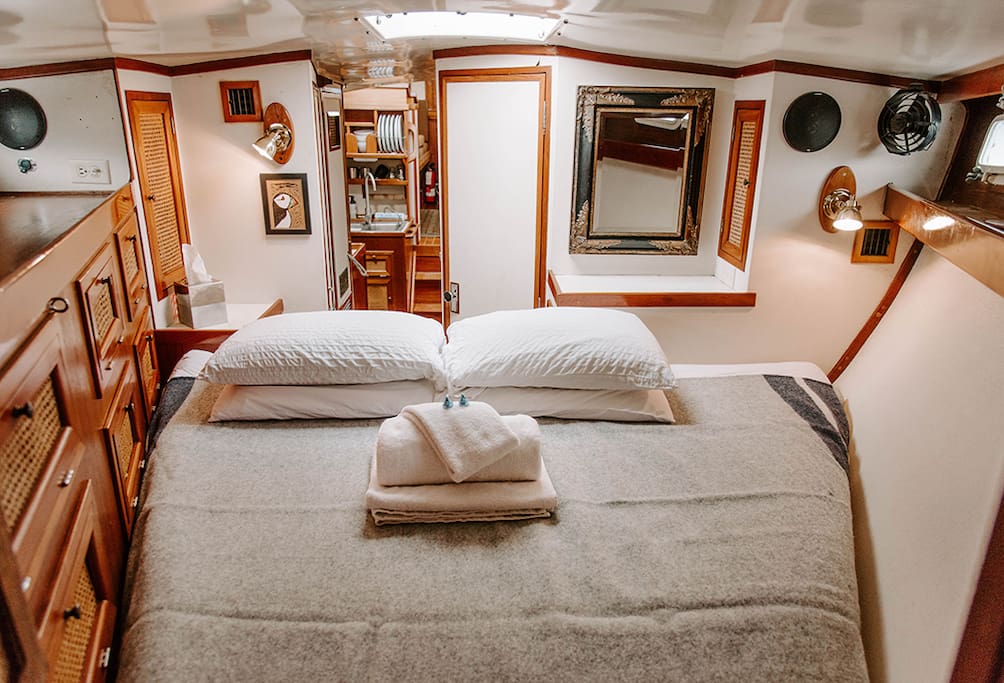 Forward cabin & main, private sleeping quarters. This v-berth bed has a custom mattress that we find very comfortable!