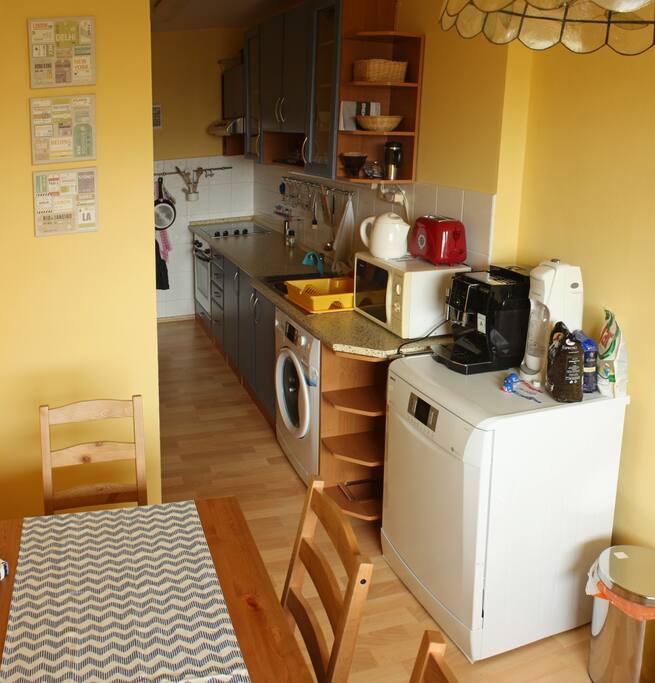 Kitchen with dish washer, coffee machine, fridge and washing machine. All at your disposal.