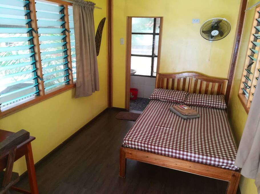 Upper room. Queen-sized bed and private balcony.
