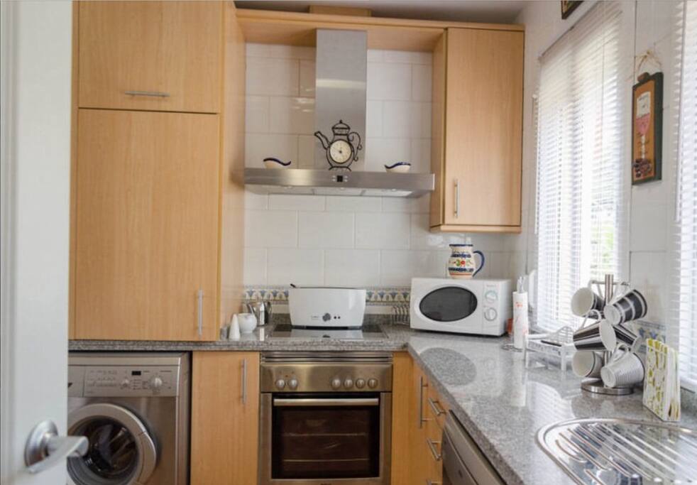 Modern kitchen with dishwasher, Huge fridge/freezer, hob/oven, washing machine.