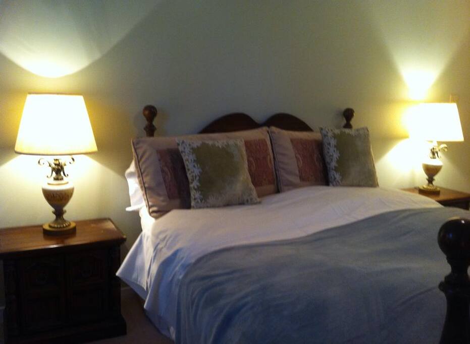 Oversized Queen Bed with high count Egyptian Linens and comfy pillows and mattress.