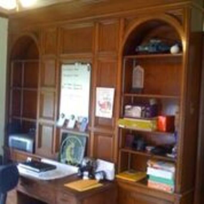 Library downstairs with lovely built-in wooden cabinets is a cozy place to relax and read.