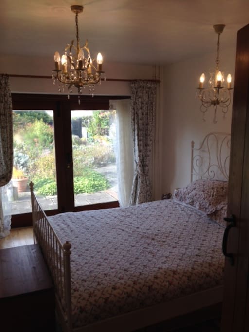 Bedroom with double bed looking out onto the garden