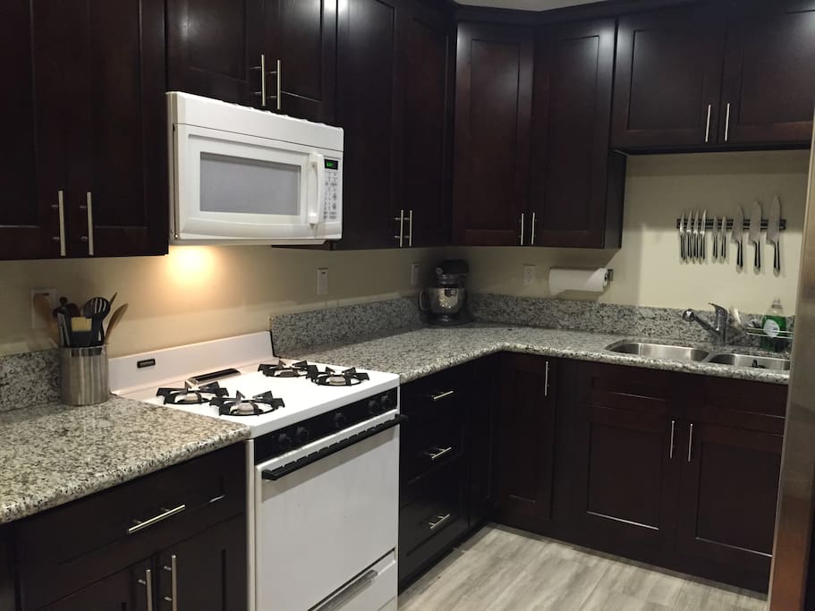Beautiful well-lit kitchen with lots of granite counter-space, gas stove, large refrigerator with water and ice-maker. Plenty of pots, pans, knives, utensils, dishes and the like for full meal preparation.