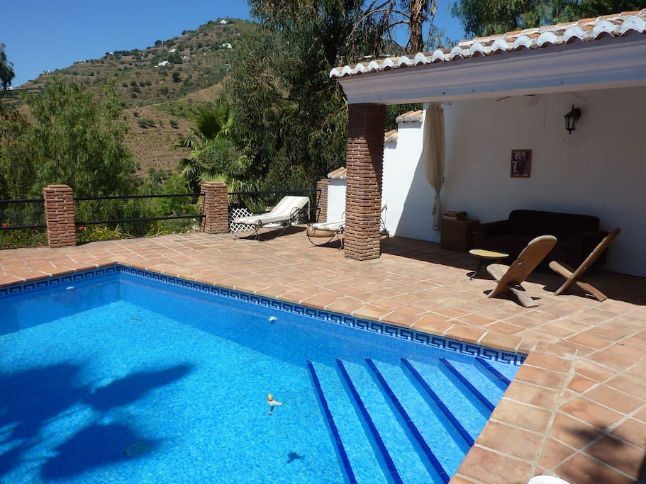 Private pool with a relaxation area with benches, coffee table and sun decks welcomes guests.