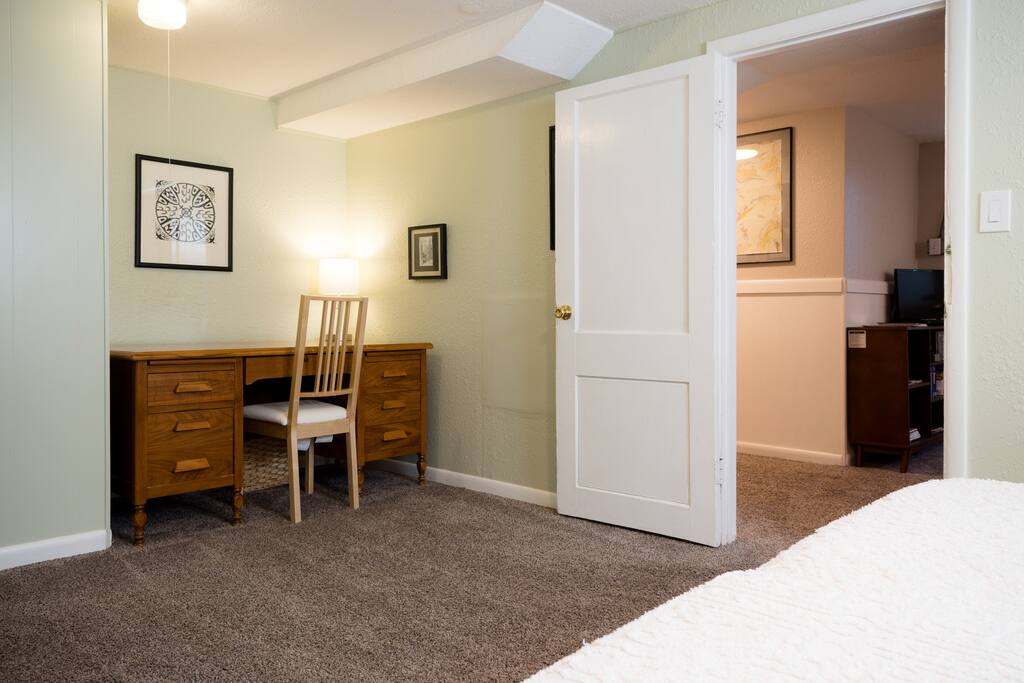 Master bedroom with large desk.