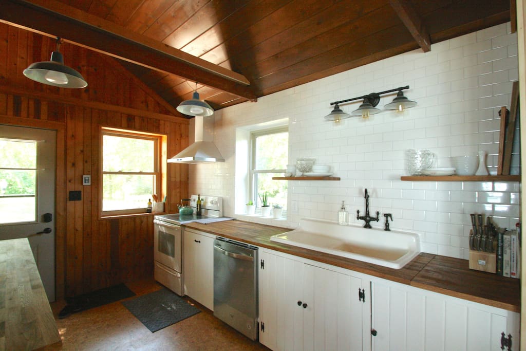 View of the fully equipped kitchen. This 1948 cottage has a lovely mix of vintage and modern features throughout.