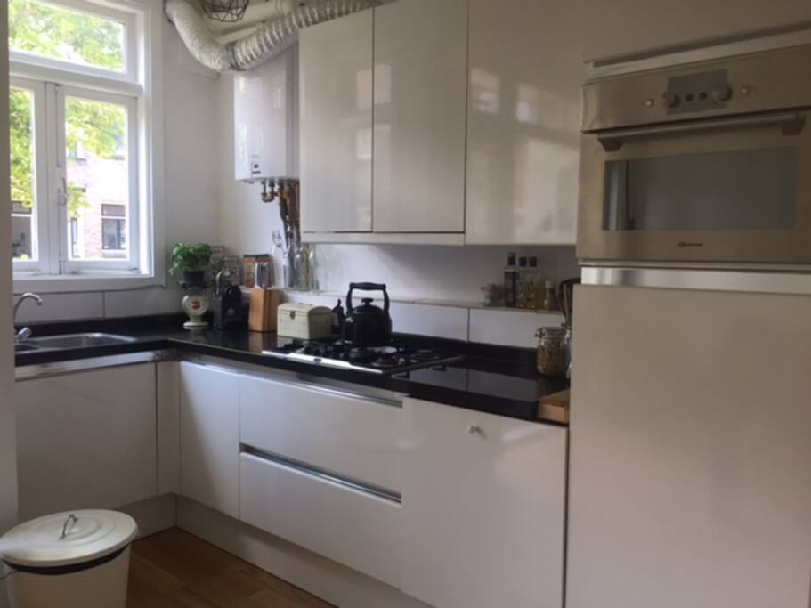Kitchen with dishwasher, oven (microwave), washing machine and dryer