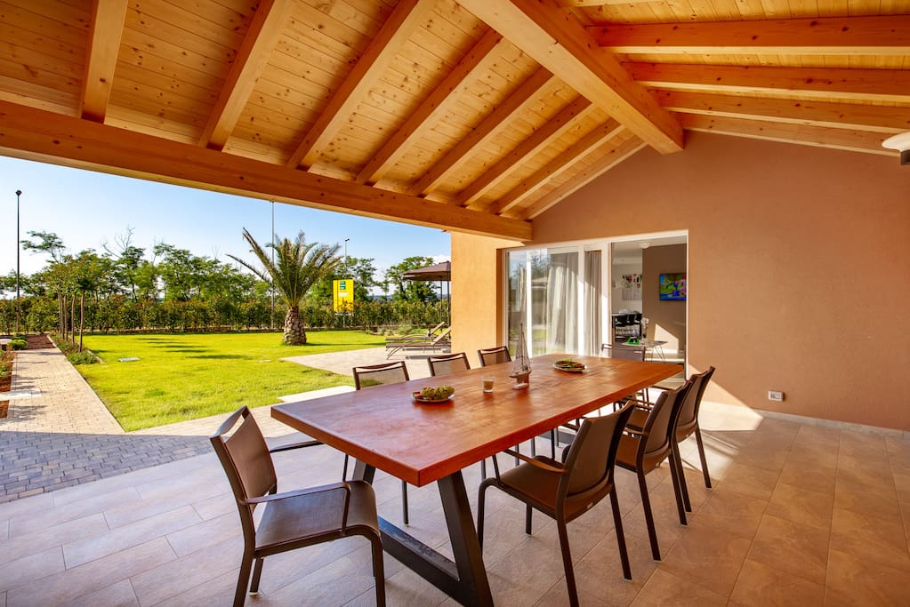 Exterior terrace with teak table and 10 chairs just for Olea house