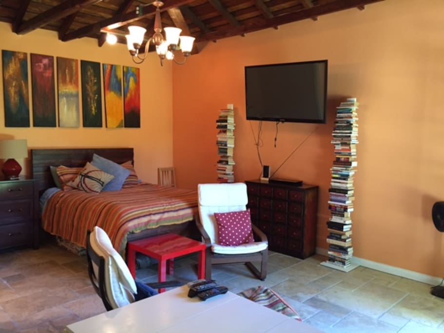Queen sized bed and wall mounted television