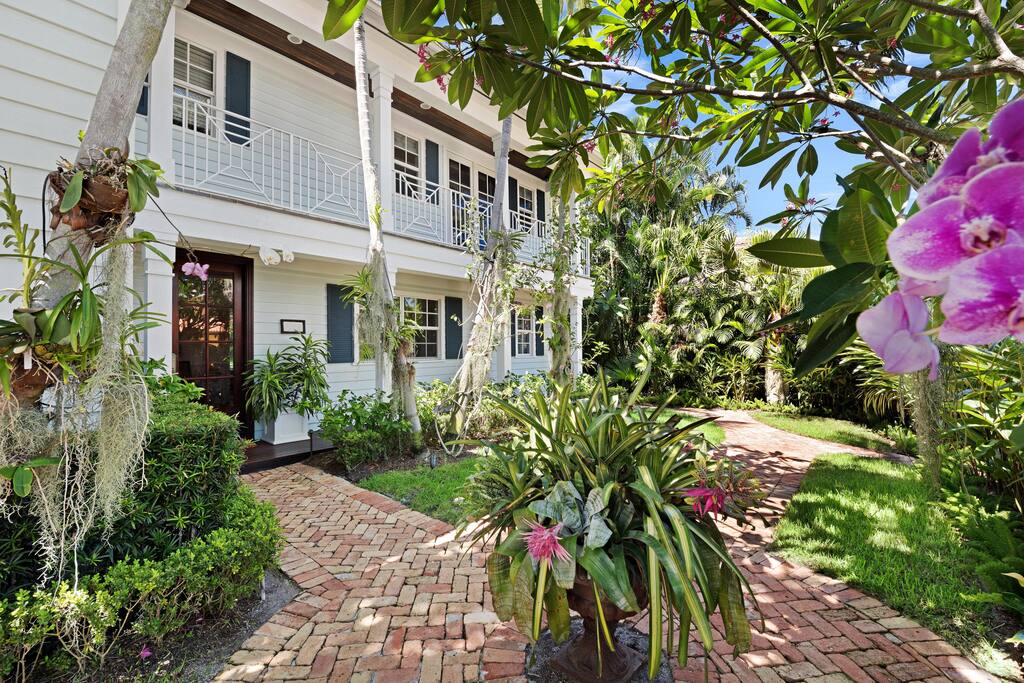 See the beautiful orchid garden in the front of the home.
