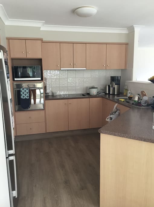 Kitchen Area: coffee machine, microwave, oven, stove top, filtered water