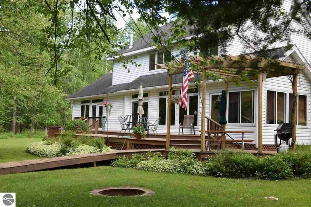 Back of home with fire pit area