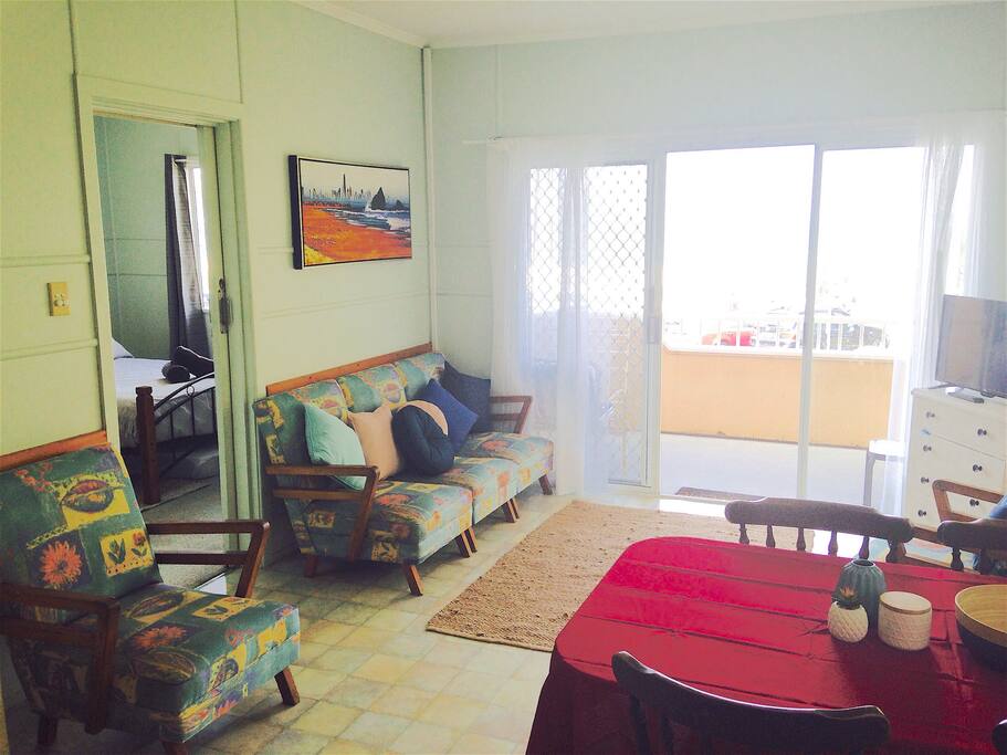 Living room with dining table opens to the balcony