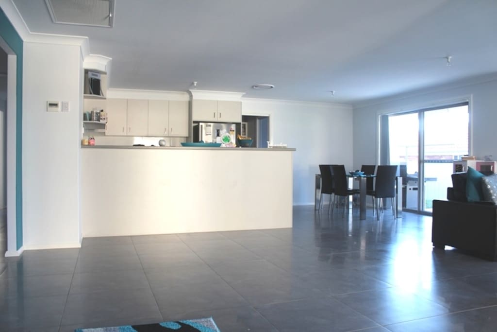 Open plan living/dining/kitchen area, with access to the outdoor dining space