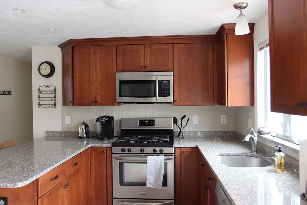 Renovated kitchen with stainless steel appliances. Fully-stocked with gas stove, dishwasher, fridge, microwave, electric kettle, Keurig coffee machine, rice cooker, toaster oven, cooking gear and basic spices.