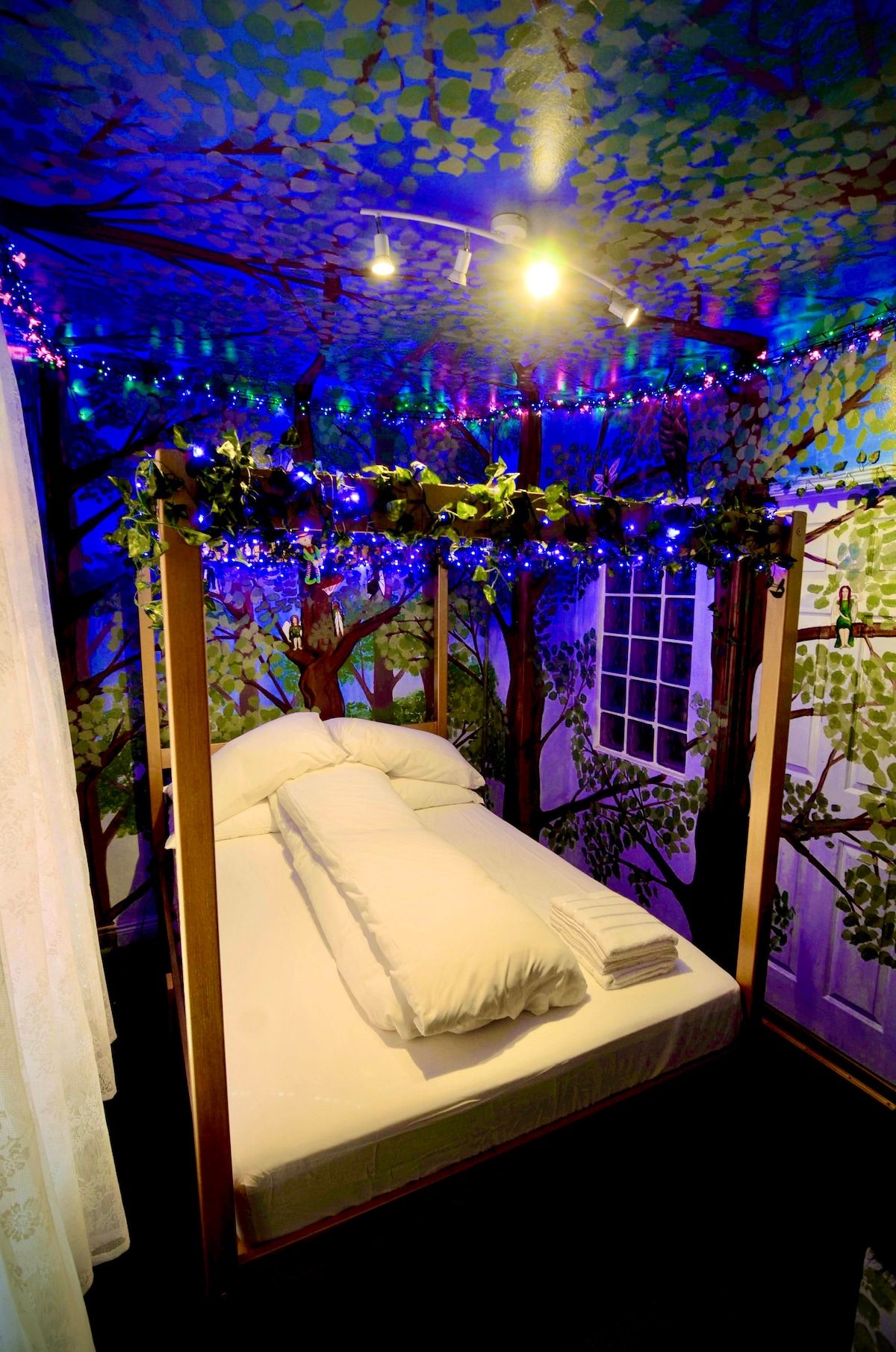 The main bedroom with the golden four poster bed safely hidden on the top of the tree, with the Irish fairies hiding on the branches. 
The bed room has 2000 LED lights 