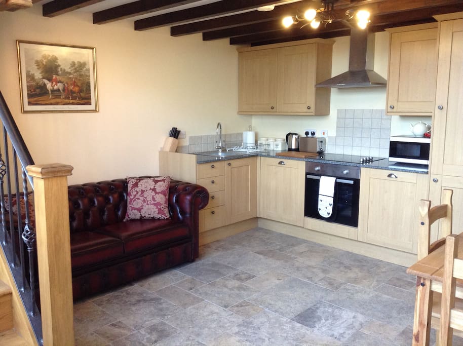 Open plan Lounge and Kitchen with 2.5 Chesterfield Sofa-bed and dining area.