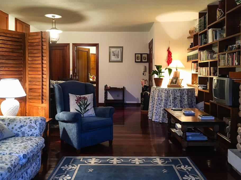 View of living room, kitchen in the background
