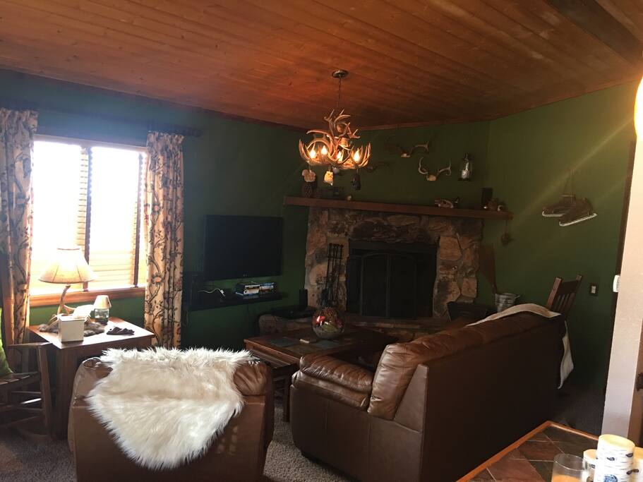 Living room with large fireplace for cozy nights.