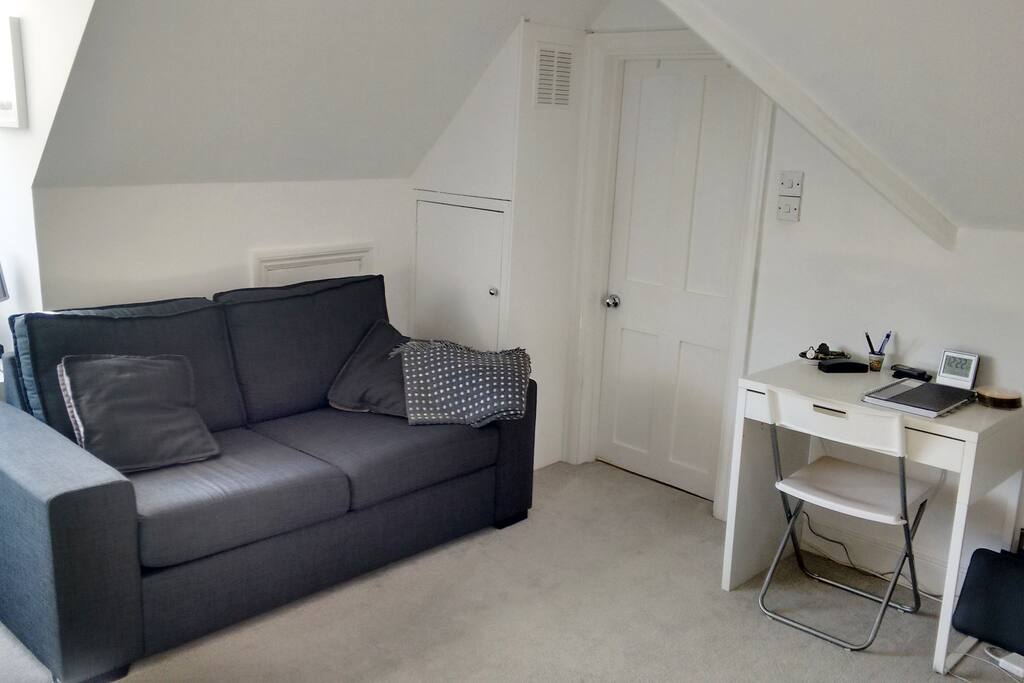 Comfortable sofa and desk area with printing facilities.