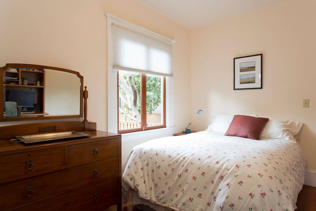 The bedroom is downstairs. It has a queen bed and is near the kitchen and bathroom