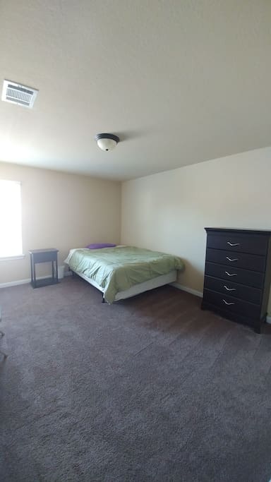 Queen bed in a spacious room