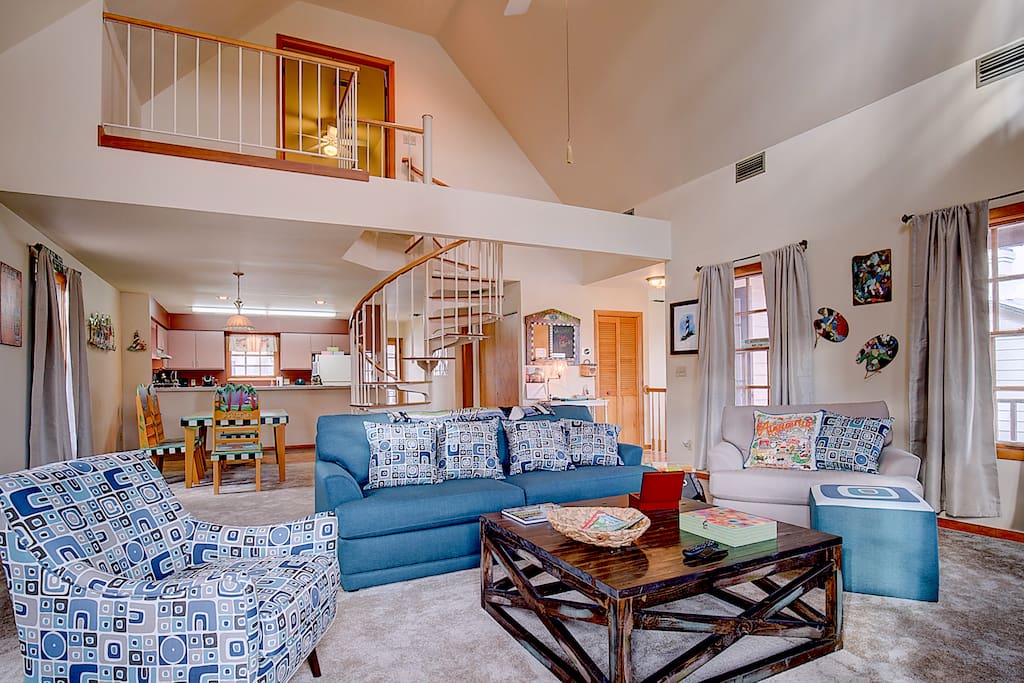 Living Room with spiral staircase to the master suite.
