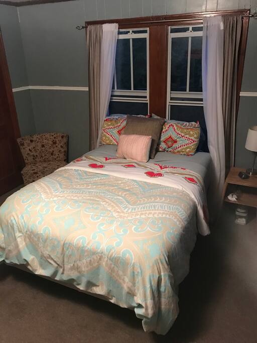 Bedroom with full bed, full private bathroom, and private entrance.