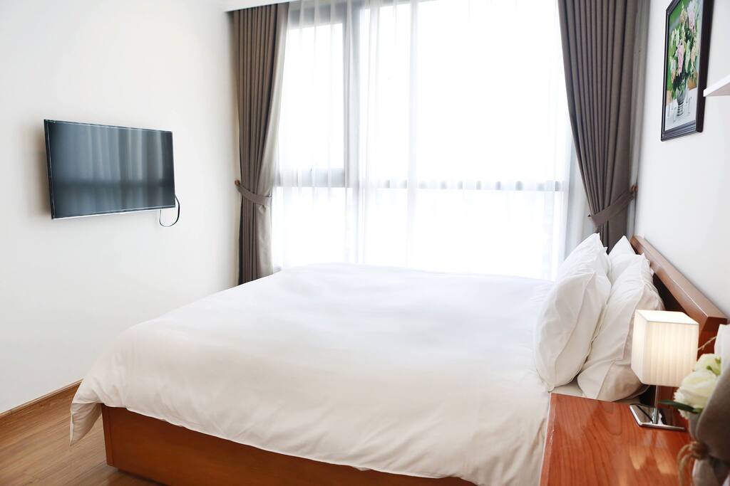 Comfy bed with thick mattress, bright natural light from big window