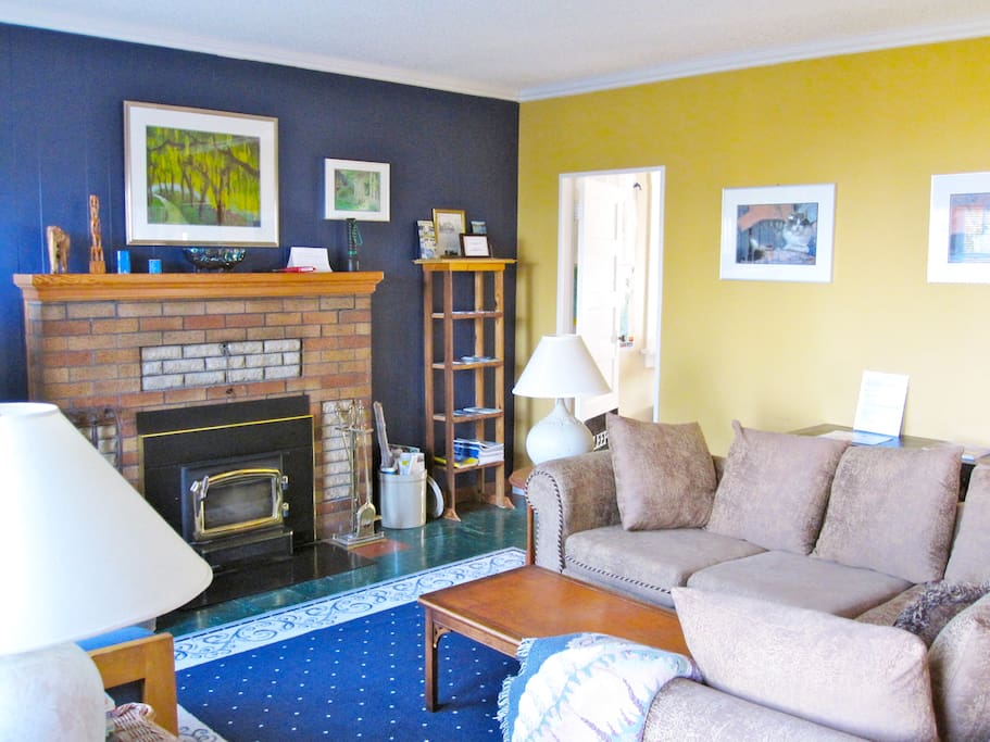 Living room features a wood burning fire place and ocean views.