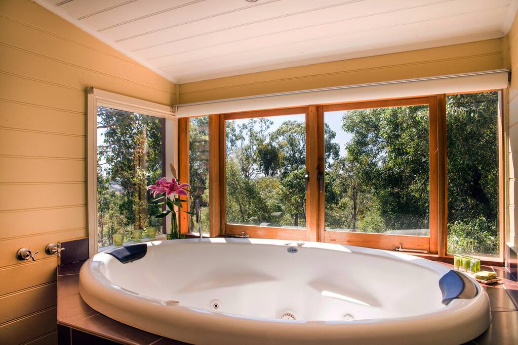 Indoor two person spa bath with views of the countryside