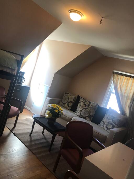 Entrance door view of seating space. Private Room w bunkbeds. & twin (rollaway ) bed for extra person.